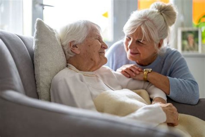 How can I get paid to take care of my elderly grandmother?